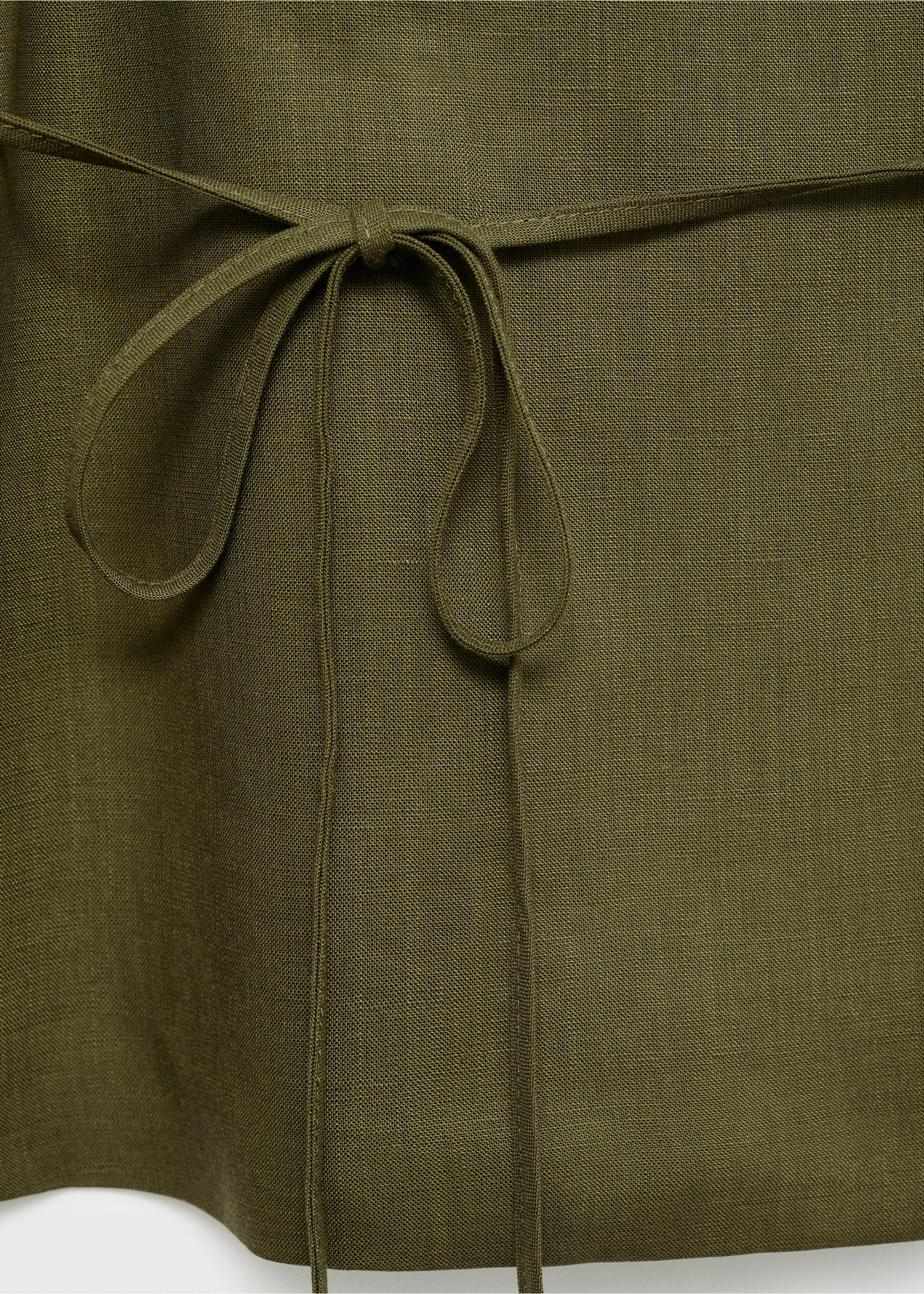 Close-up of a dark khaki green top showing textured fabric and a waist tie., Khaki. Ref: 87078640-00.