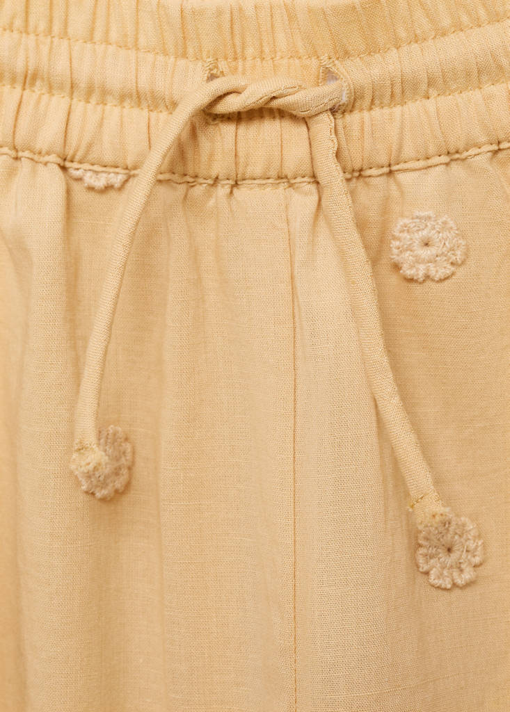 Long trousers with embroidered details — Mustard
