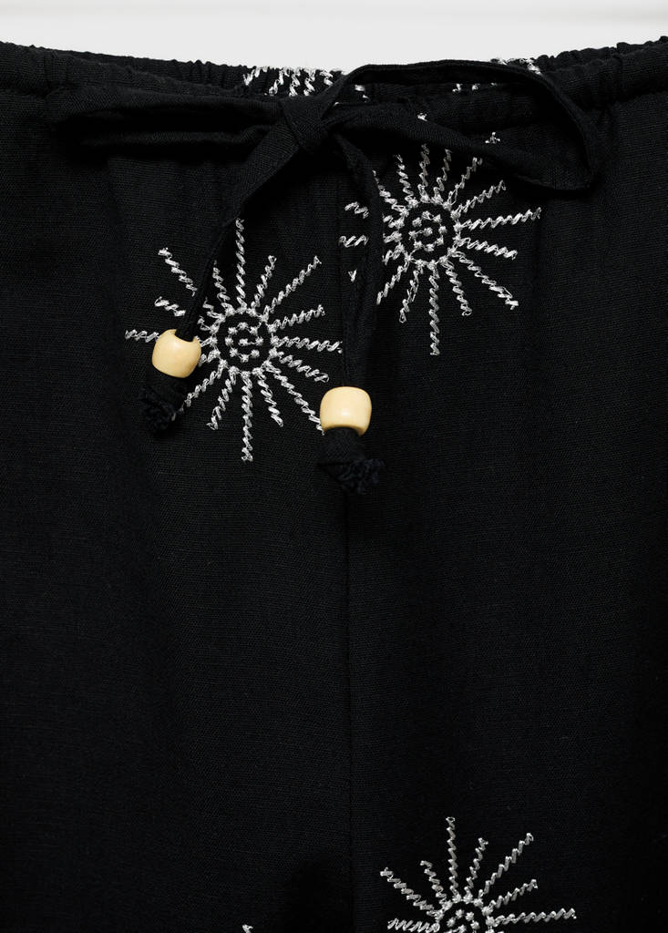 Long trousers with embroidered details — Black