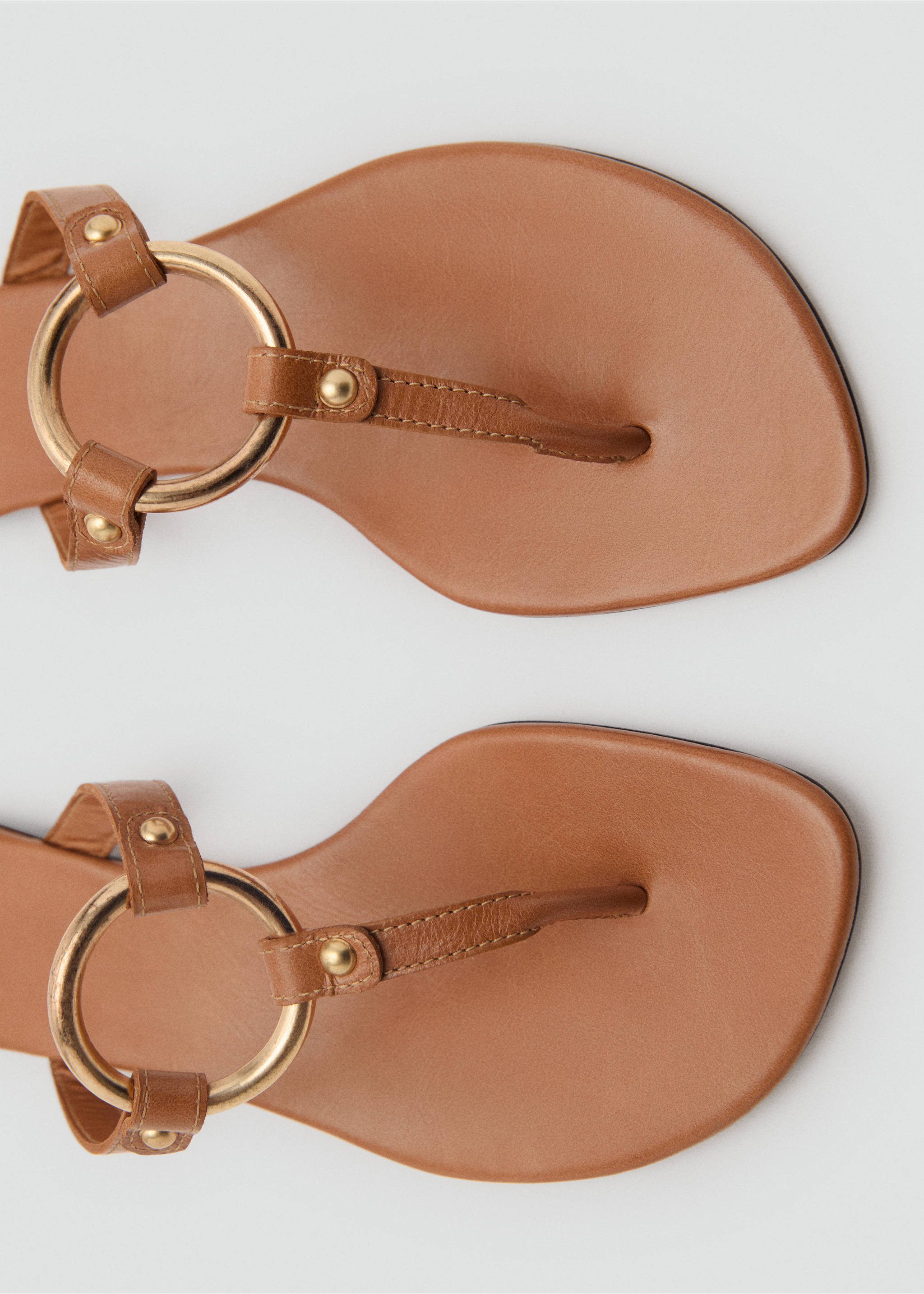 Close-up of brown leather sandals with a gold-tone metal ring detail., Medium Brown. Ref: 87095993-00.