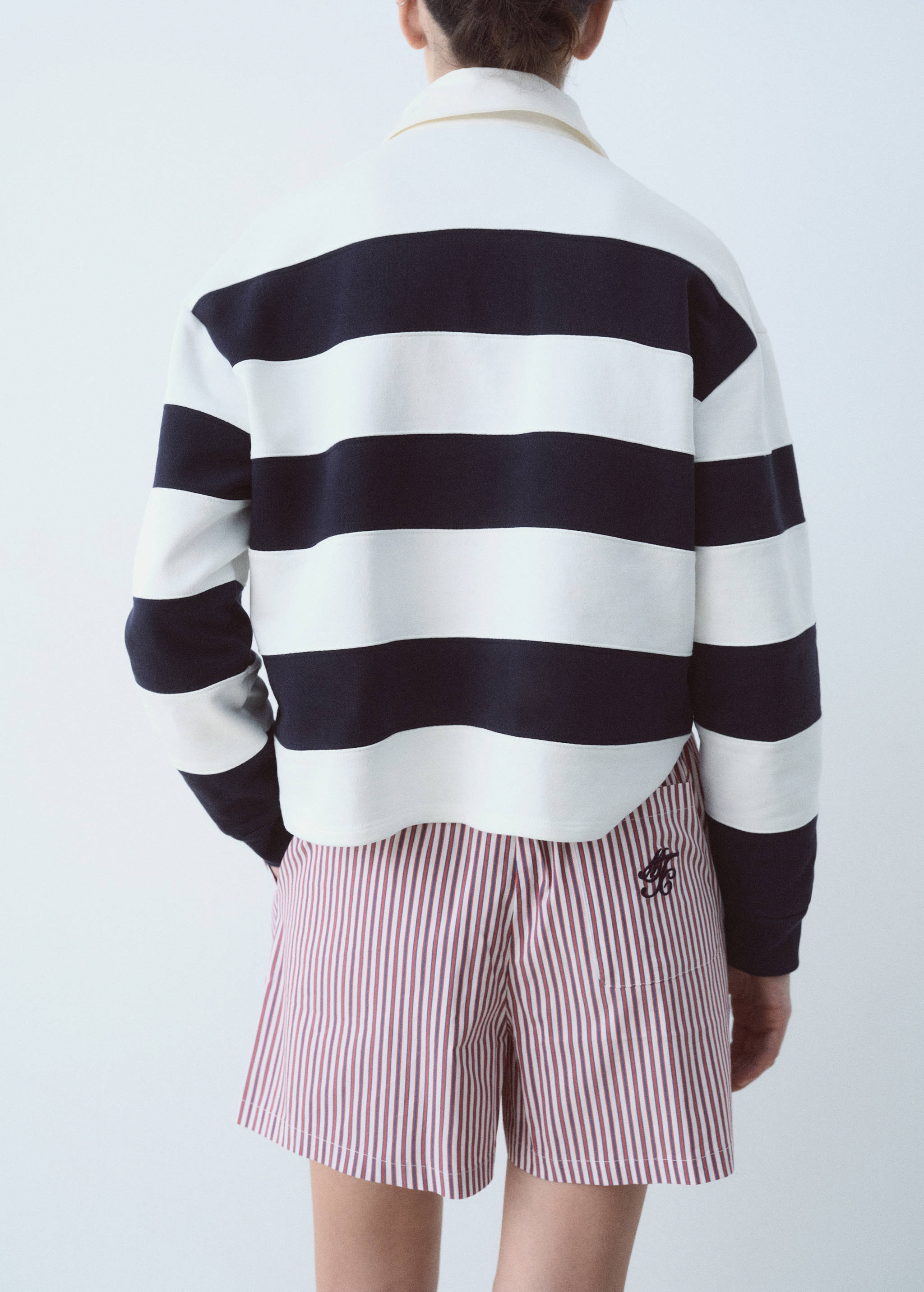Striped polo shirt with embroidered message - Reverse of the article