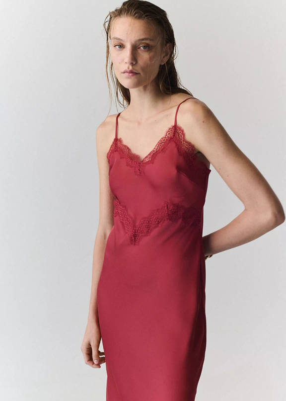 A red slip dress with lace detailing at the neckline and waist
