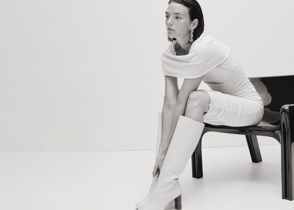 Woman wearing a high boots outfit with an elegant dress