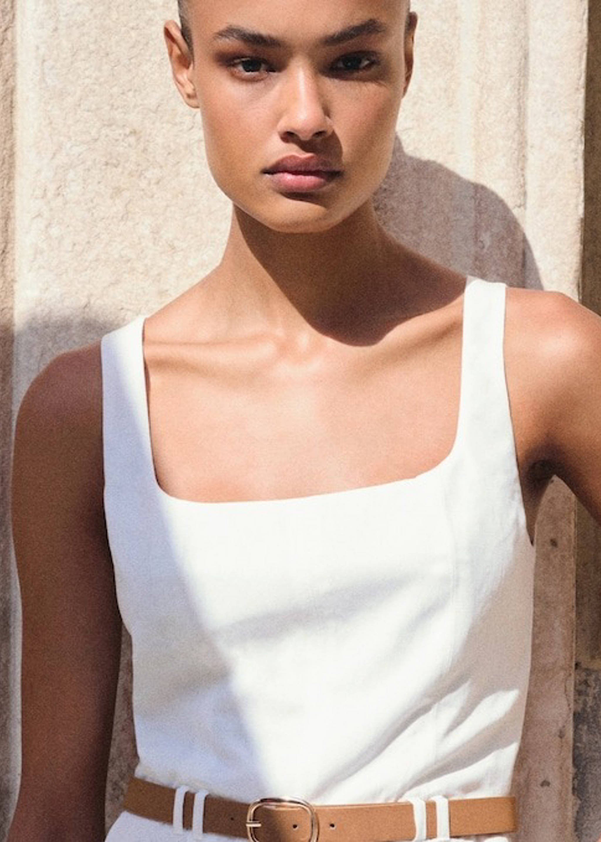 Woman wearing basic garments for a capsule wardrobe.