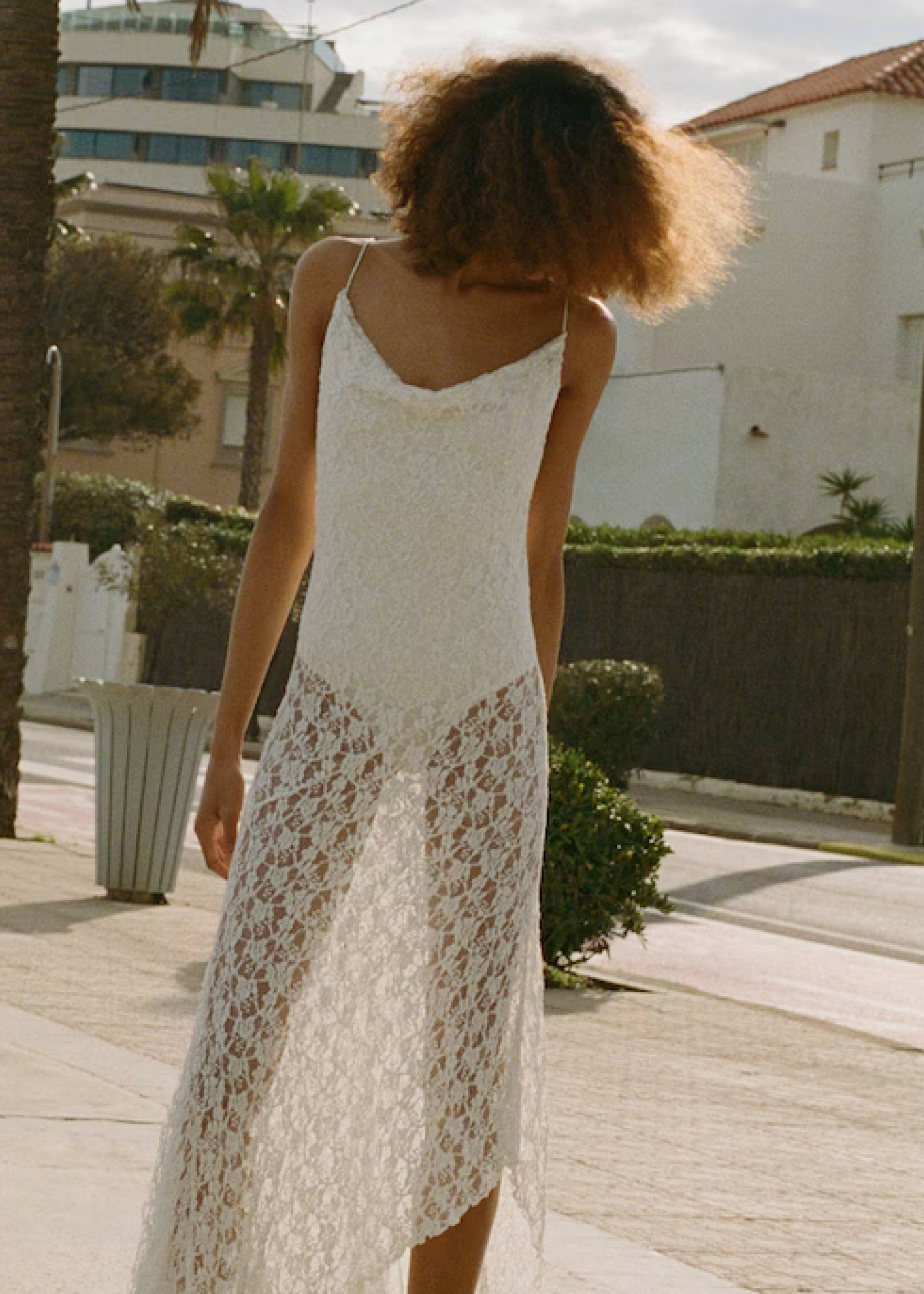 Woman wearing a festival look with a colorful skirt and a white top.