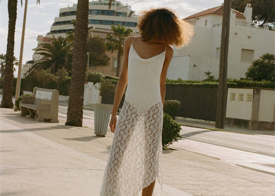 Woman wearing a festival look with a colorful skirt and a white top.