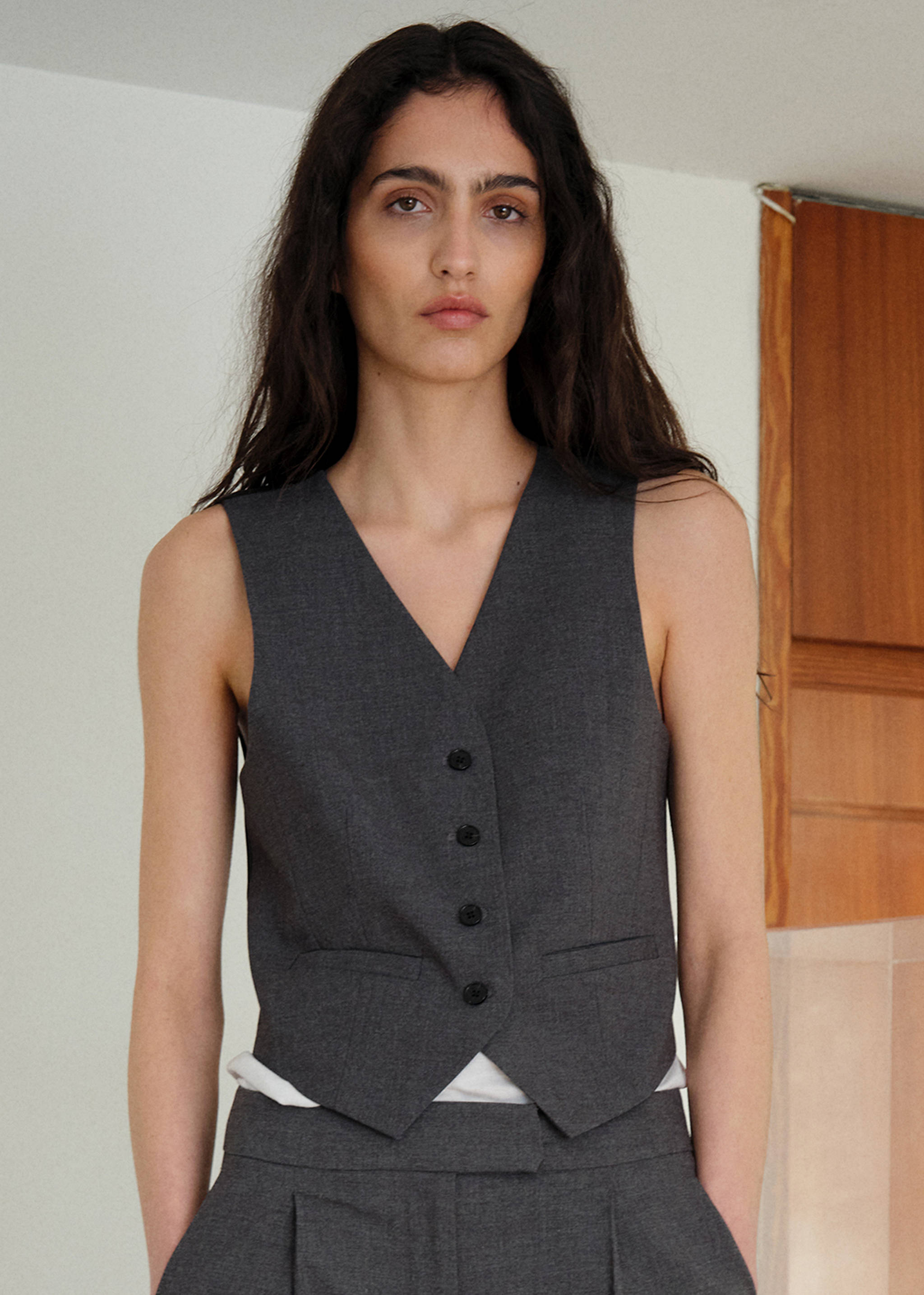 Woman wearing an outfit with a white quilted vest