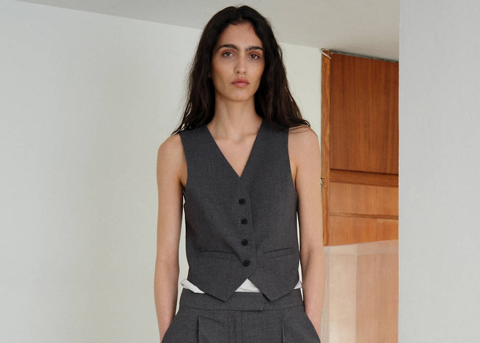 Woman wearing an outfit with a white quilted waistcoat