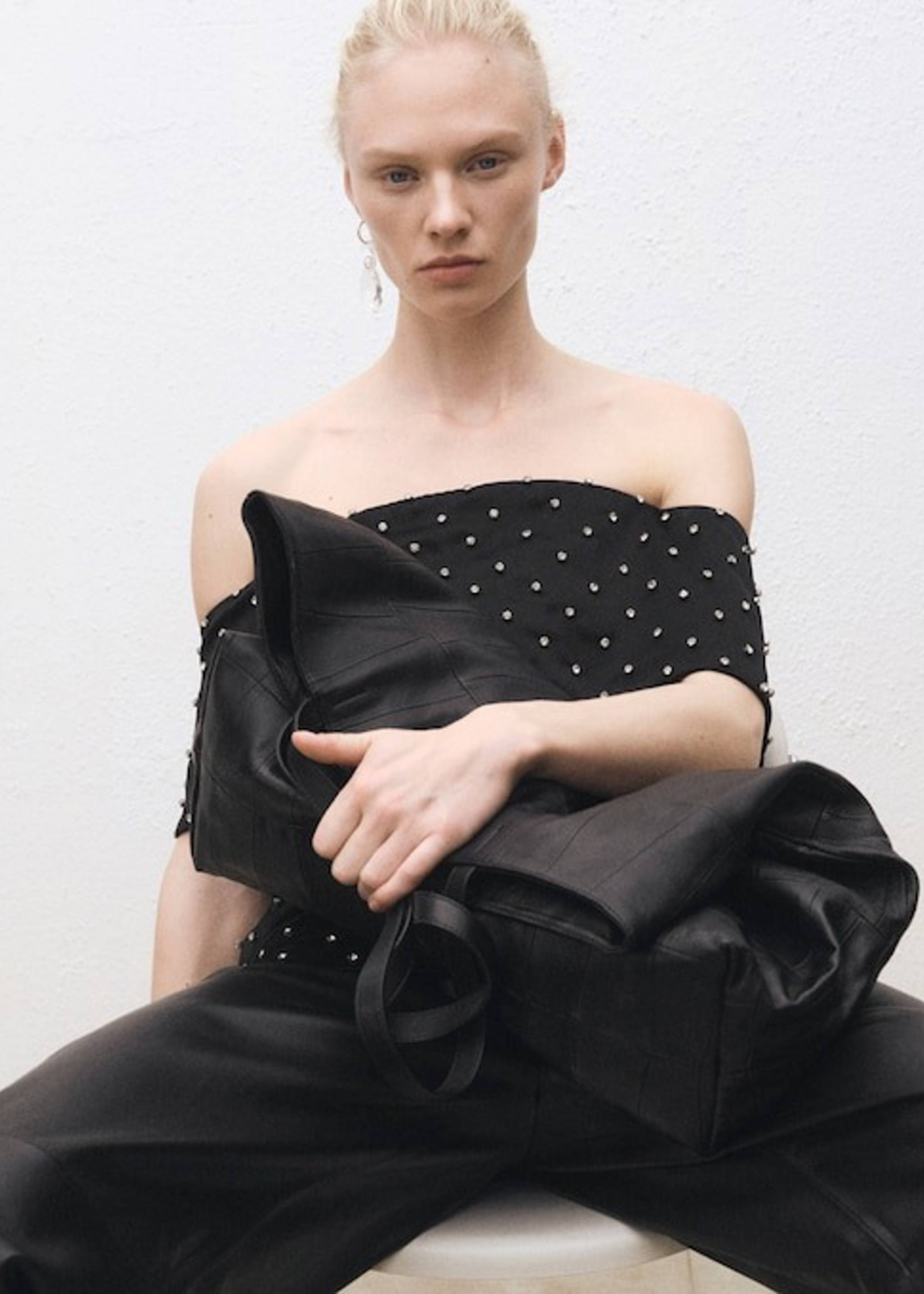 Woman wearing a look with leather pants and a white shirt