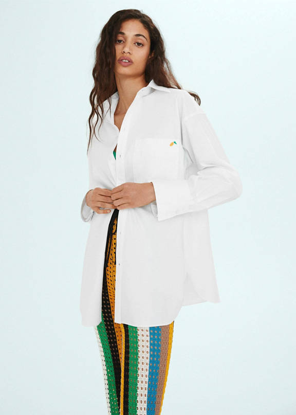 Girl wearing a look with an oversized white shirt.