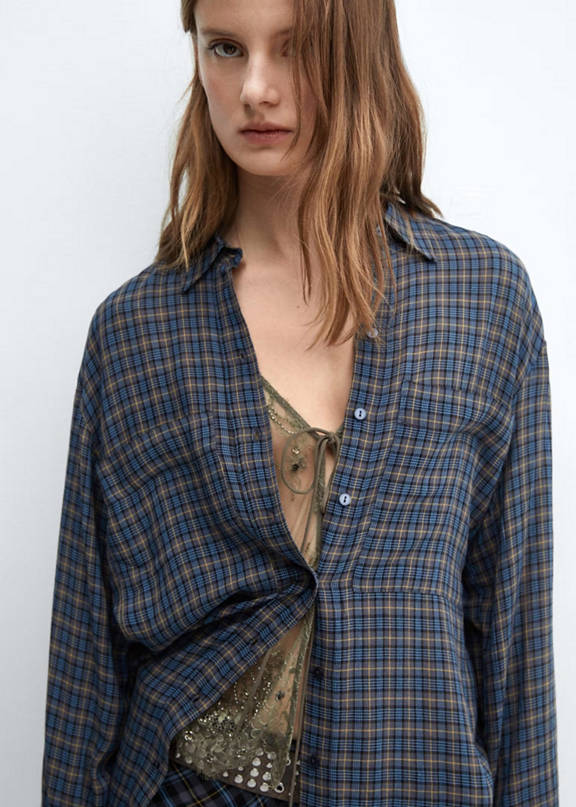 Woman wearing a grunge style oversize plaid shirt