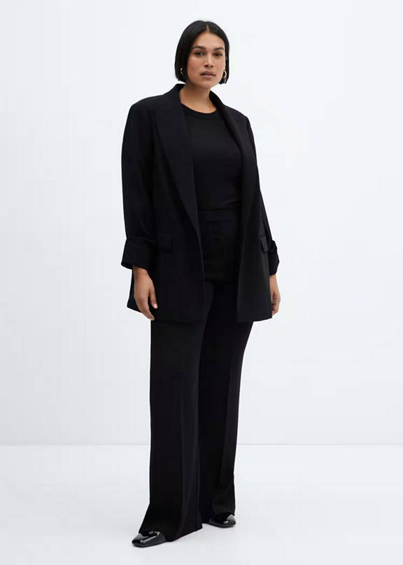 Woman wearing a minimalist style black jacket suit