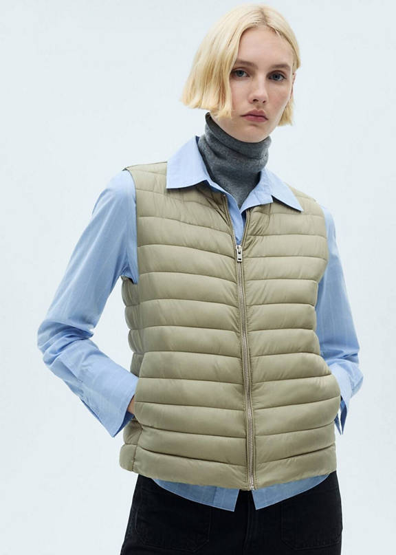 Girl wearing an outfit with a green quilted waistcoat.