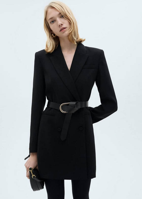 Girl dressed in a little black dress with a black belt