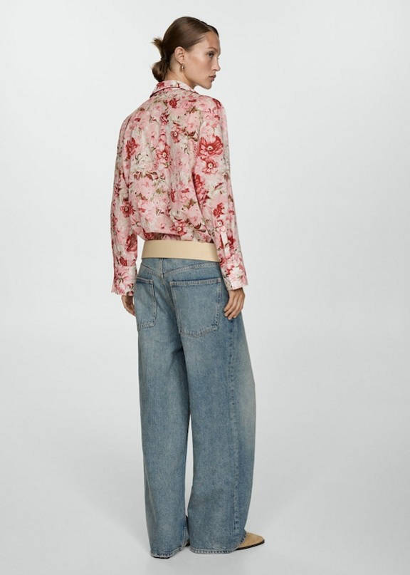 Woman wearing a denim outfit with a boho blouse