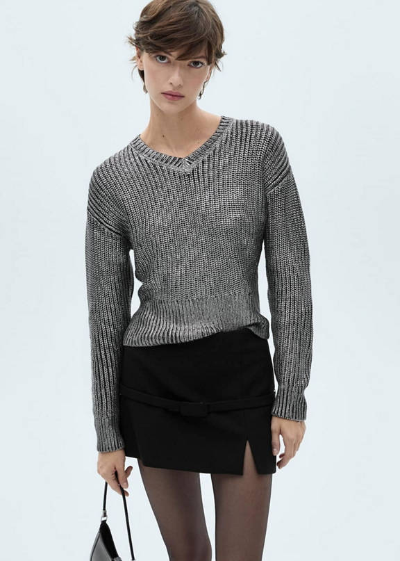A women's outfit for Christmas 2025 with a printed sweater.
