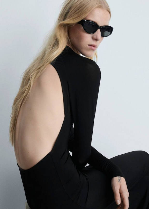 An outfit with a black dress with the back in the air.