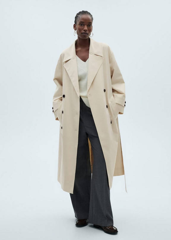 Girl with a look of beige trench coat and brown pants