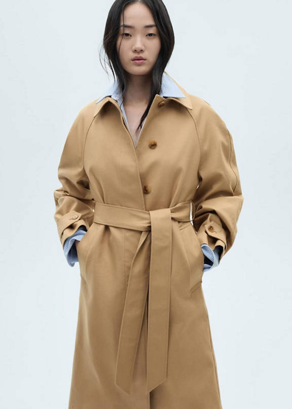 Woman wearing a look with camel trench coat and red sweater