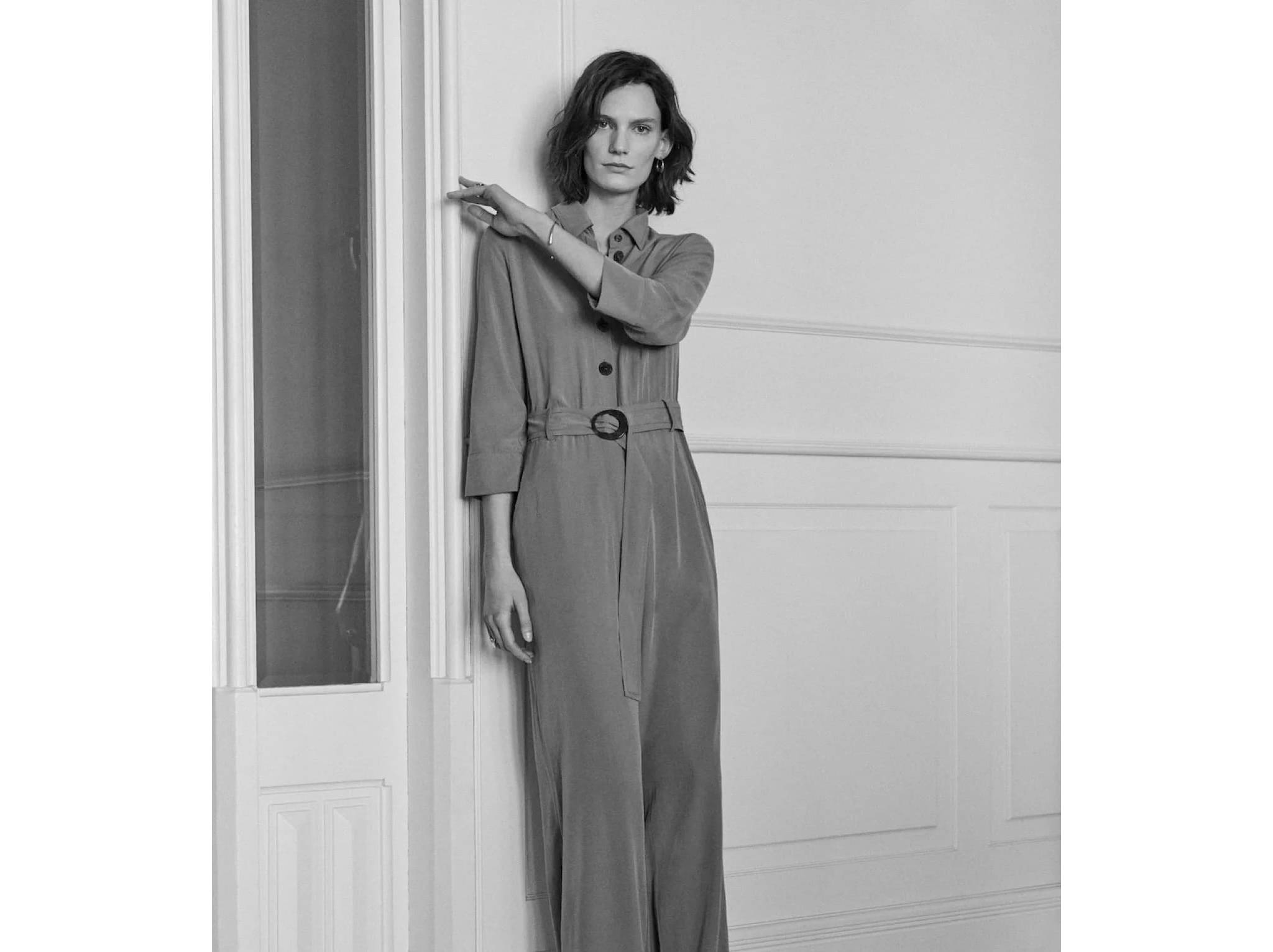 Black and white image of a woman in a long dress